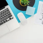 Top view of laptop, computer mouse, plant, website design template on abstract geometric background